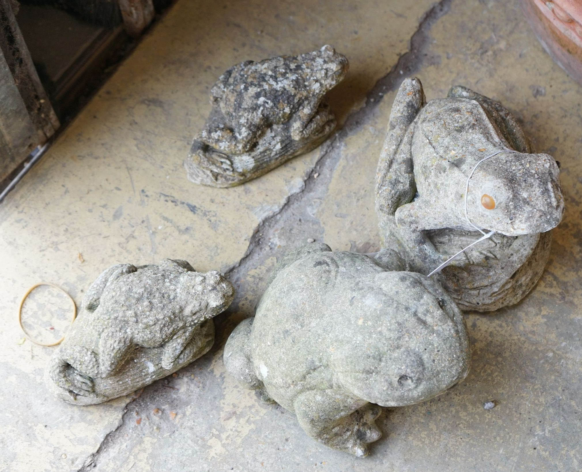 Four reconstituted stone frog garden ornaments, largest height 15cm